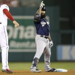 Milwaukee Brewers' Eric Thames, center, gestures to his teammate after hitting a double during the fourth inning of a National League wild card baseball game against the Washington Nationals at Nationals Park, Tuesday, Oct. 1, 2019, in Washington. (AP Photo/Andrew Harnik)