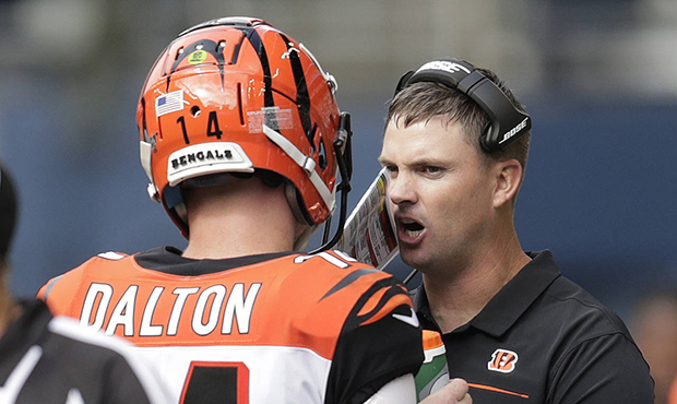 Cincinnati Bengals head coach Zac Taylor, right, talks with quarterback Andy Dalton, left, during t...