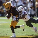 Arizona State running back Eno Benjamin (3) is pulled down by Washington State safety Skyler Thomas (25) during the first half of an NCAA college football game Saturday, Oct. 12, 2019, in Tempe, Ariz. (AP Photo/Ross D. Franklin)