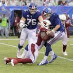 Arizona Cardinals' Terrell Suggs, front left, knocks the ball out of New York Giants quarterback Daniel Jones' hands during the second half of an NFL football game, Sunday, Oct. 20, 2019, in East Rutherford, N.J. (AP Photo/Bill Kostroun)