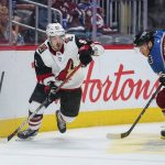 Arizona Coyotes right wing Conor Garland (83) moves the puck against Colorado Avalanche left wing Andre Burakovsky (95) during the second period of an NHL hockey game, Saturday, Oct. 12, 2019, in Denver (AP Photo/Jack Dempsey)
