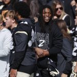 Injured Colorado wide receiver Laviska Shenault Jr. jokes with teammates in the first half of an NCAA college football game against Arizona Saturday, Oct. 5, 2019, in Boulder, Colo. (AP Photo/David Zalubowski)