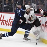 Winnipeg Jets' Patrik Laine (29) checks Arizona Coyotes' Jason Demers (55) during the second period of an NHL hockey game Tuesday, Oct. 15, 2019, in Winnipeg, Manitoba. (Fred Greenslade/The Canadian Press via AP)