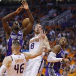 Sacramento Kings forward Harrison Barnes, top left, is fouled by Phoenix Suns center Aron Baynes (46) during the first half of an NBA basketball game Wednesday, Oct. 23, 2019, in Phoenix. (AP Photo/Rick Scuteri)