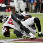 Atlanta Falcons wide receiver Calvin Ridley, left, scores a touchdown as Arizona Cardinals defensive back Jalen Thompson defends during the first half of an NFL football game, Sunday, Oct. 13, 2019, in Glendale, Ariz. (AP Photo/Rick Scuteri)