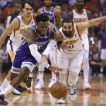 Sacramento Kings guard Buddy Hield and Phoenix Suns guard Ricky Rubio (11) reach for the ball during the first half of an NBA basketball game Wednesday, Oct. 23, 2019, in Phoenix. (AP Photo/Rick Scuteri)