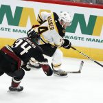 Boston Bruins' Chris Wagner (14) controls the puck against the Arizona Coyotes' Carl Soderberg (34) during the third period of an NHL hockey game Saturday, Oct. 5, 2019, in Glendale, Ariz. (AP Photo/Darryl Webb)