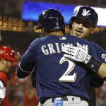 Milwaukee Brewers' Yasmani Grandal, right, celebrates with teammate Trent Grisham after batting Grisham in on a home run in the first inning of a National League wild card baseball game against the Washington Nationals, Tuesday, Oct. 1, 2019, in Washington. (AP Photo/Patrick Semansky)