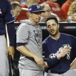Milwaukee Brewers manager Craig Counsell, center, speaks with left fielder Ryan Braun, right, in the dugout in the fifth inning of a National League wild card baseball game against the Washington Nationals, Tuesday, Oct. 1, 2019, in Washington. (AP Photo/Patrick Semansky)