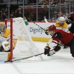 Nashville Predators goaltender Juuse Saros (74) makes a save on Arizona Coyotes left wing Lawson Crouse (67) during the second period of an NHL hockey game Thursday, Oct. 17, 2019, in Glendale, Ariz. (AP Photo/Rick Scuteri)