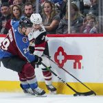 Colorado Avalanche center Nathan MacKinnon (29) moves the puck against Arizona Coyotes defenseman Jakob Chychrun (6) during the first period of an NHL hockey game, Saturday, Oct. 12, 2019, in Denver (AP Photo/Jack Dempsey)