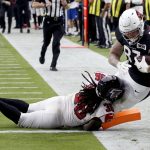 Arizona Cardinals tight end Maxx Williams (87) scores a touchdown as Atlanta Falcons defensive back Kemal Ishmael (36) defends during the second half of an NFL football game, Sunday, Oct. 13, 2019, in Glendale, Ariz. (AP Photo/Ross D. Franklin)
