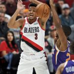 Portland Trail Blazers guard CJ McCollum, left, loses the ball while being defended by Phoenix Suns forward Mikal Bridges during the first half of a preseason NBA basketball game in Portland, Ore., Saturday, Oct. 12, 2019. (AP Photo/Craig Mitchelldyer)