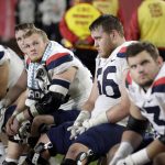 Arizona players sit on the bench in the closing minutes of a 41-14 loss to Southern California during an NCAA college football game Saturday, Oct. 19, 2019, in Los Angeles. (AP Photo/Marcio Jose Sanchez)