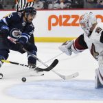 Arizona Coyotes goaltender Darcy Kuemper (35) makes a save on Winnipeg Jets' Mathieu Perreault (85) during the second period of an NHL hockey game Tuesday, Oct. 15, 2019, in Winnipeg, Manitoba. (Fred Greenslade/The Canadian Press via AP)