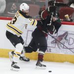 Boston Bruins' Charlie Coyle (13) shoves the Arizona Coyotes' Phil Kessel (81) during the second period of an NHL hockey game Saturday, Oct. 5, 2019, in Glendale, Ariz. (AP Photo/Darryl Webb)
