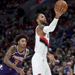 Portland Trail Blazers guard Gary Trent Jr., right, shoots in front of Phoenix Suns forward Kelly Oubre Jr. during the first half of a preseason NBA basketball game in Portland, Ore., Saturday, Oct. 12, 2019. (AP Photo/Craig Mitchelldyer)