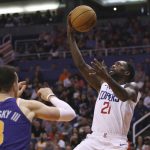 LA Clippers guard Patrick Beverley (21) scores against Phoenix Suns forward Frank Kaminsky (8) during the first half of a basketball game Saturday, Oct. 26, 2019, in Phoenix. (AP Photo/Ross D. Franklin)