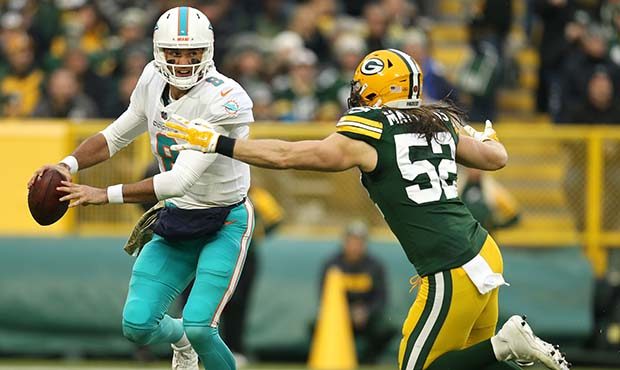 GREEN BAY, WI - NOVEMBER 11:  Brock Osweiler #8 of the Miami Dolphins attempts to avoid being tackl...