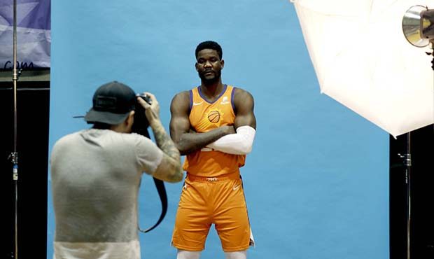 NBA photographer Michael Gonzalez photographs Phoenix Suns' DeAndre Ayton during media day at the N...