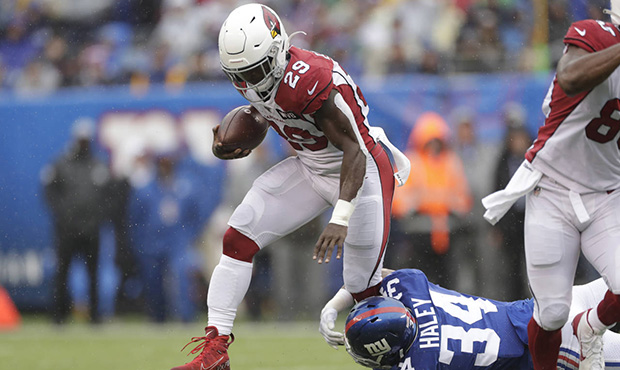 Arizona Cardinals' Chase Edmonds runs the ball during the first half of an NFL football game agains...