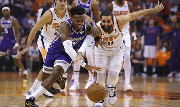 Sacramento Kings guard Buddy Hield and Phoenix Suns guard Ricky Rubio (11) reach for the ball durin...