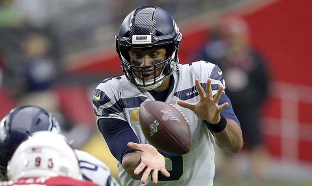 Seattle Seahawks quarterback Russell Wilson takes the snap against the Arizona Cardinals during the...