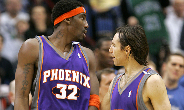 Phoenix Suns guard Steve Nash (13) of Canada holds center Amare Stoudemire (32) back from Minnesota...