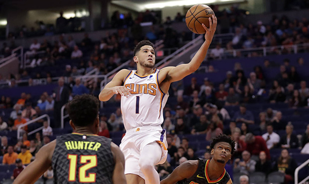 Phoenix Suns guard Devin Booker (1) shoots over Atlanta Hawks forward De'Andre Hunter (12) during t...
