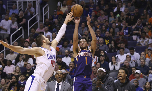 Phoenix Suns guard Devin Booker (1) shoots over LA Clippers center Ivica Zubac (40) during the seco...