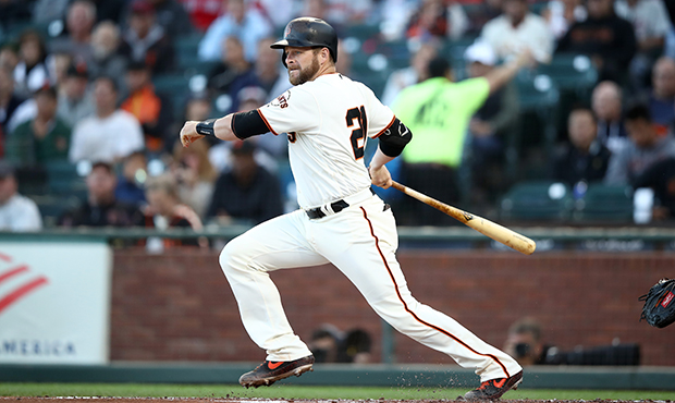 Stephen Vogt #21 of the San Francisco Giants hits a single that scored a run in the first inning ag...