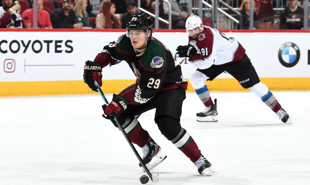 Barrett Hayton #29 of the Arizona Coyotes advances the puck up ice against the Colorado Avalanche d...