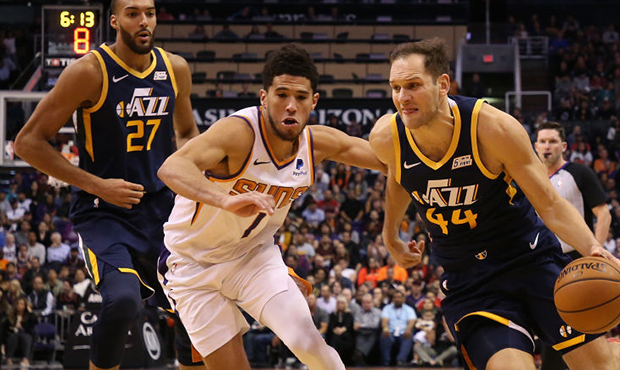 Bojan Bogdanovic #44 of the Utah Jazz drives the ball past Devin Booker #1 of the Phoenix Suns duri...