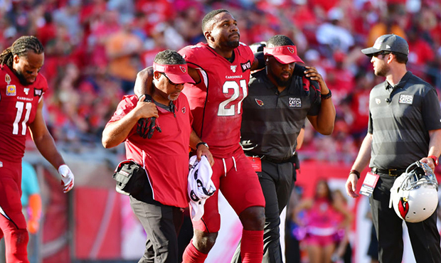 Patrick Peterson #21 of the Arizona Cardinals is helped off the field after an injury during the fo...