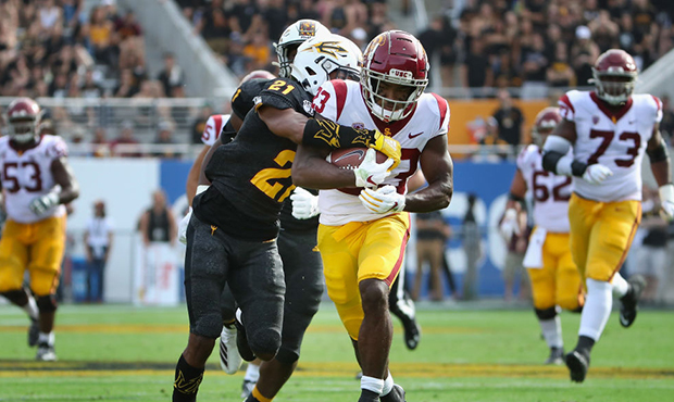 Running back Kenan Christon #23 of the USC Trojans runs with the football en route to scoring on a ...