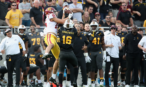 Wide receiver Drake London #15 of the USC Trojans makes a reception over safety Aashari Crosswell #...