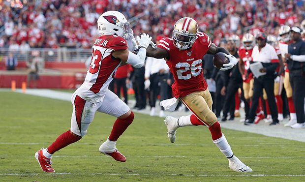 Running back Tevin Coleman #26 of the San Francisco 49ers runs with the football against cornerback...