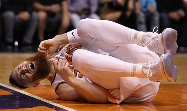 Aron Baynes #46 of the Phoenix Suns reacts after taking a knee from the Boston Celtics during the s...