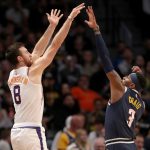 DENVER, COLORADO - NOVEMBER 24: Frank Kaminsky III #8 of the Phoenix Suns puts up a shot over Torrey Craig #3 of the Denver Nuggets in the second quarter at the Pepsi Center on November 24, 2019 in Denver, Colorado.  NOTE TO USER: User expressly acknowledges and agrees that, by downloading and or using this photograph, User is consenting to the terms and conditions of the Getty Images License Agreement.  (Photo by Matthew Stockman/Getty Images)