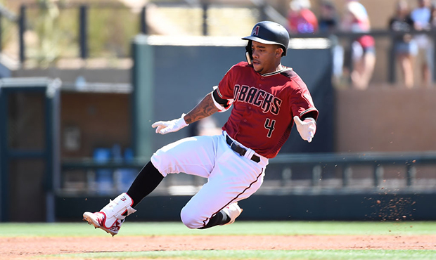 Ketel Marte #4 of the Arizona Diamondbacks slides into second base after hitting a double during th...
