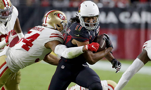 Arizona Cardinals wide receiver Larry Fitzgerald (11) is hit by San Francisco 49ers middle lineback...
