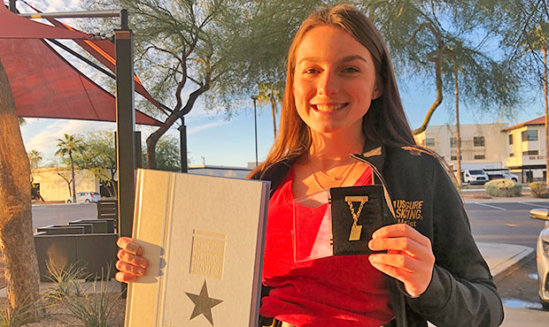 17-year-old Lauren Kobley displays her Veterans Heritage Project book and figure skating gold medal...