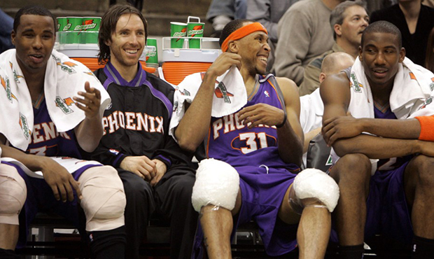 Members of the Phoenix Suns share a laugh on the bench during the fourth quarter as they beat the M...