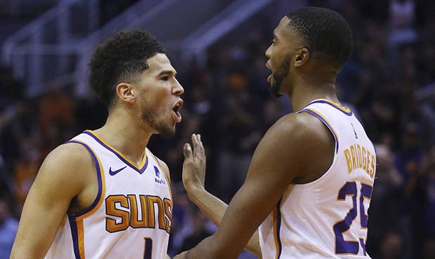 Phoenix Suns guard Devin Booker (1) shouts at Philadelphia 76ers players after scoring and being fo...