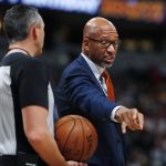 Phoenix Suns head coach Monty Williams, right, argues for a call with referee Eli Roe in the first half of an NBA basketball game against the Denver Nuggets, Sunday, Nov. 24, 2019, in Denver. (AP Photo/David Zalubowski)