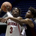 Arizona guard Dylan Smith, left, gets fouled by Penn guard Lucas Monroe going to the basket during the second half of an NCAA college basketball game at the Wooden Legacy tournament in Anaheim, Calif., Friday, Nov. 29, 2019. (AP Photo/Alex Gallardo)