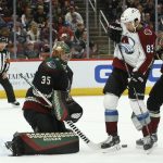 Arizona Coyotes goaltender Darcy Kuemper (35) makes a save as Colorado Avalanche left wing Matt Nieto (83) and Coyotes center Carl Soderberg (34) battle for position during the first period of an NHL hockey game Saturday, Nov. 2, 2019, in Glendale, Ariz. (AP Photo/Ross D. Franklin)