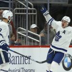 Toronto Maple Leafs center Auston Matthews, right, celebrates his goal against the Arizona Coyotes with defenseman Jake Muzzin (8) during the third period of an NHL hockey game Thursday, Nov. 21, 2019, in Glendale, Ariz. The Maple Leafs won 3-1. (AP Photo/Ross D. Franklin)