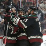 Arizona Coyotes center Vinnie Hinostroza, center, celebrates with Jordan Oesterle (82) and Brad Richardson (15) in the second period during an NHL hockey game against the Minnesota Wild, Saturday, Nov. 9, 2019, in Glendale, Ariz. (AP Photo/Rick Scuteri)