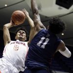 Arizona guard Josh Green, left, goes up against Pennsylvania guard Lucas Monroe, right, during the first half of an NCAA college basketball game at the Wooden Legacy tournament in Anaheim, Calif., Friday, Nov. 29, 2019. (AP Photo/Alex Gallardo)